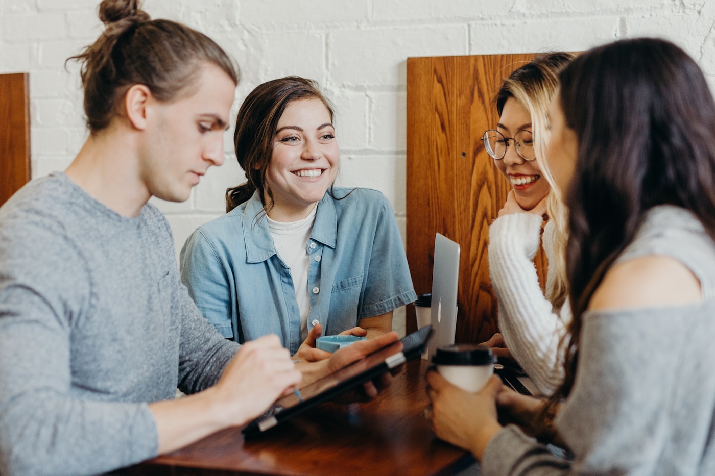 A group of colleagues laughing together over coffee